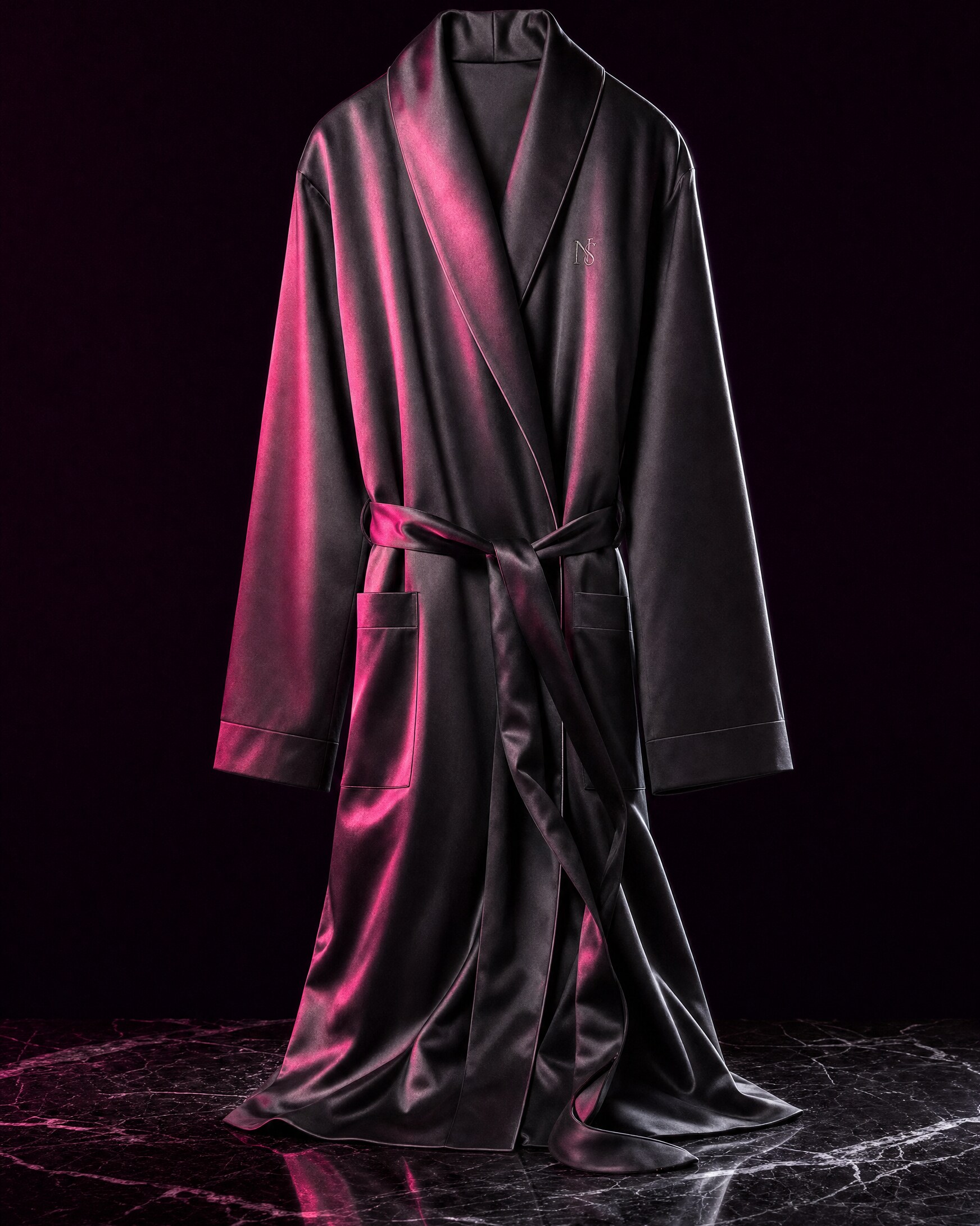 graphite satin robe draped across midnight marble