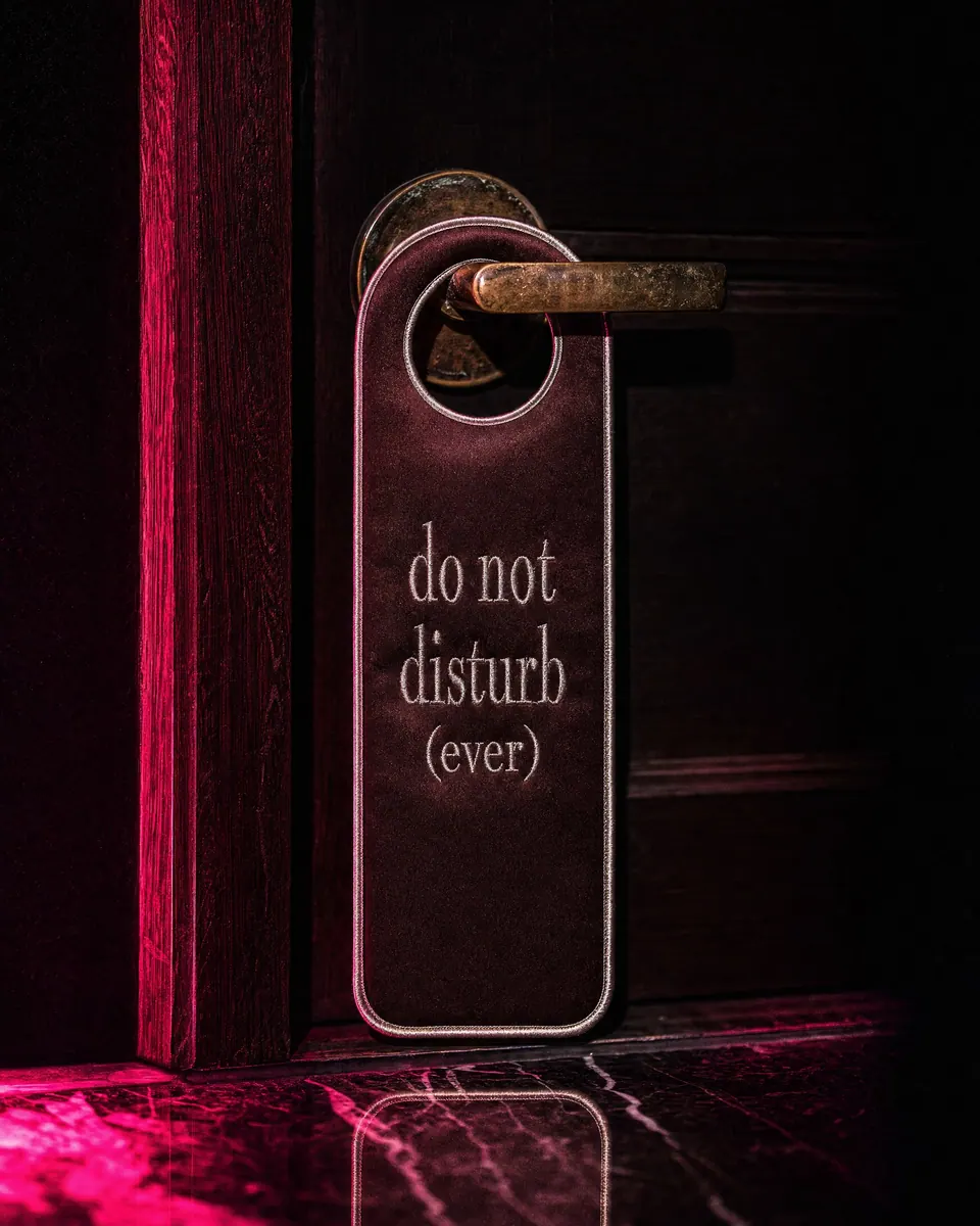 satin door hanger on a dark hotel door